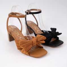 Our CARA heel is designed with a pleated bow and leather heel. Heel Height: 2.75" Spring High Heels With Bow Straps, Chic Block Heels With Bow And Low Heel, Chic Spring Heels With Bow, Summer Block Heels With Bow Straps, Chic Block Heel Heels With Bow, Chic Block Heels With Bow, Elegant Bow Block Heels For Spring, Elegant Spring Block Heels With Bow, Spring Low Heel Shoes With Bow Straps