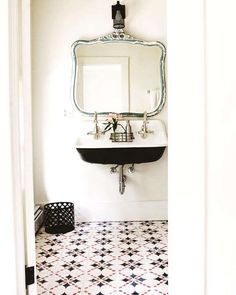 a bathroom with a sink and mirror in it