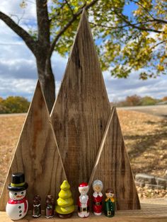 a group of wooden christmas trees sitting next to each other