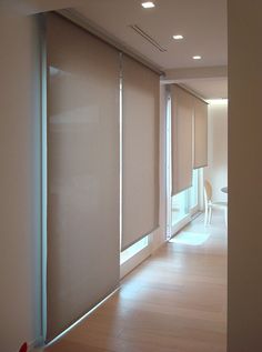 an empty room with sliding glass doors and hard wood flooring