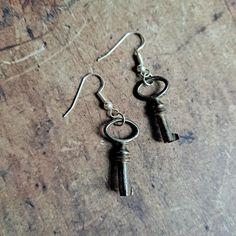 A lovely set of two tiny antique keys upcycled into an unusual pair of earrings.  Great condition and ready to be loved all over again. These are genuine antique keys, however the earring hook is a modern stainless steel one which I have added so they are ready to wear.   Free UK delivery as standard. Always wrapped beautifully in plastic free packaging. Academia Jewelry, Dark Academia Jewelry, Key Earrings, Antique Keys, Earring Hook, To Be Loved, Dangly Earrings, Dark Academia, Plastic Free