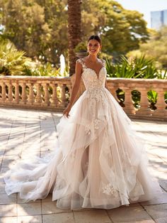 Layered floral lace ballgown with horsehair hem and sparkle tulle. Sampled in bridal size 20, in ivory/latte/nude (color pictured). Can be ordered in size 2-28 in ivory/latte/nude or all ivory.