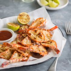 grilled shrimp served with dipping sauce and lemon wedges