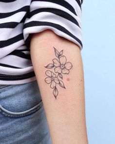 a woman with a flower tattoo on her arm