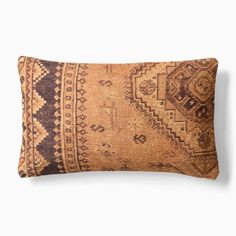 a brown and black decorative pillow on a white background