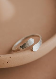 An updated version of our cuff ring. This time we made the ends pass by one another. Inspired by the definition of sonder: the realization that each random passerby is living a life as vivid and complex as your own. 14g wire is hand-shaped and hammered for texture. Available in 14kt Gold Fill + Sterling Silver. Shown with our Confetti Rings and Raye Ring. Handmade in Eau Claire, WI All of our jewelry is handmade to order so each piece will be unique and may vary slightly from what is pictured. Confetti Rings, Poppy Ring, Things To Ask, Copper Uses, Everyday Wear Jewelry, Jewelry Photos, Ring Inspo, Cuff Ring, Cuff Rings