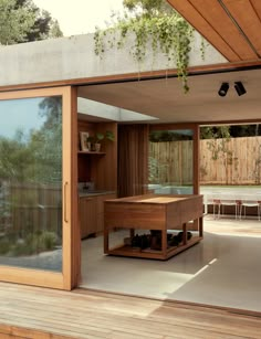 an open room with wooden flooring and sliding glass doors leading to a deck area