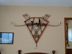 a wall mounted clock with arrows on it