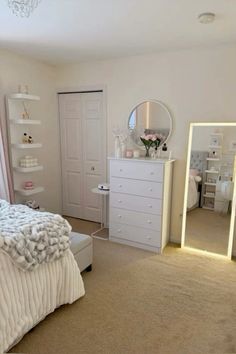 a bedroom with a bed, dresser and mirror