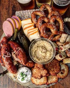 a platter filled with pretzels, sausages, and other food items