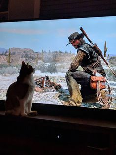 a cat sitting in front of a television with a man on it's screen