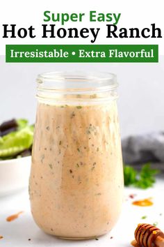 a jar filled with ranch dressing next to a bowl of lettuce