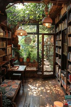 a room filled with lots of books next to a window covered in plants and hanging lights