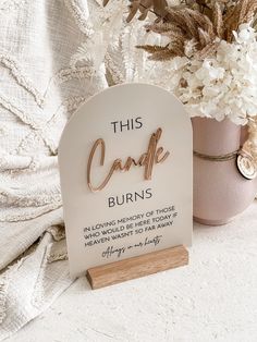 this candle burns plaque is next to a potted plant