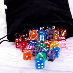 colorful dices sitting on top of a black bag