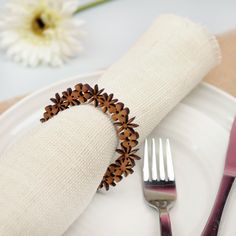 a white plate topped with a fork and knife next to a napkin on top of a table