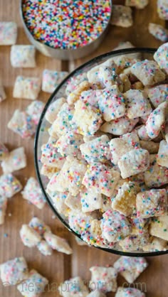 colorful sprinkles and sugar cubes in a bowl on a wooden table