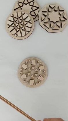 the video shows how to make laser cut coasters with wood and glue on them