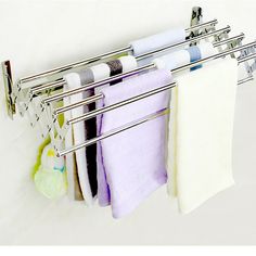 the towel rack is holding several folded towels