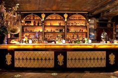 an old fashioned bar with lots of bottles on it