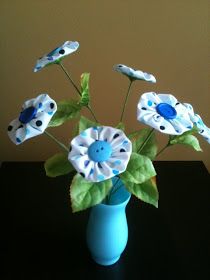 a blue vase filled with flowers on top of a table