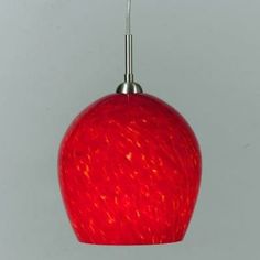 a red glass light hanging from a ceiling