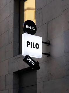 a hotel sign hanging off the side of a building