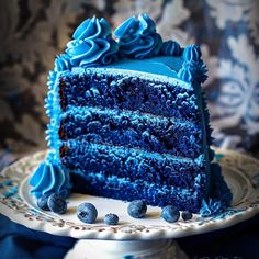 a slice of blue cake on a white plate