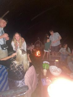 a group of people sitting around a fire pit