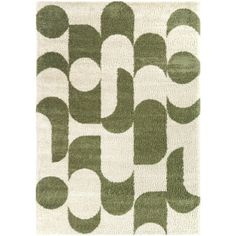 a green and white area rug with circles on it's sides, in the shape of an abstract design