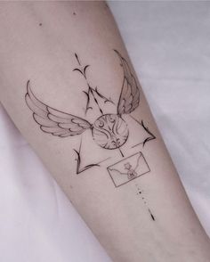 a tattoo on the arm of a person with an envelope and bird flying above it