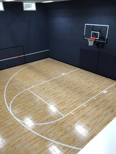 an indoor basketball court with wooden flooring and white lines on the sidelines is shown