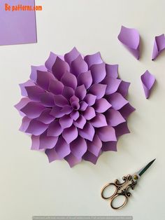 paper flowers and scissors on a table