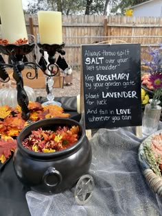 a table topped with lots of flowers next to a chalkboard that says salt and water