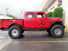 a red truck parked in front of a building