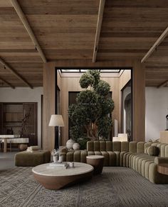 a living room filled with lots of furniture next to a tall tree in the corner