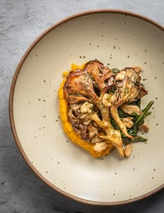 a white bowl filled with food on top of a table