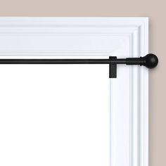 an open window with a black curtain rod