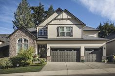 a large house with two garages in the front and one on the other side