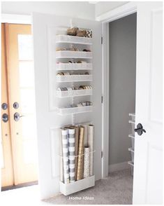 a white closet filled with lots of different types of wrappings and other things in it