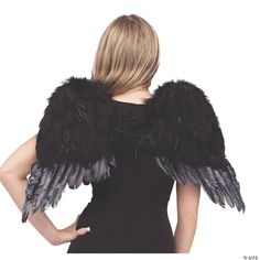 a woman in a black dress with an angel wings on her back and arms behind her