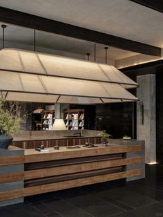 a large kitchen with wooden counter tops and black tile flooring