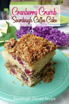 cranberry crumb sourdough coffee cake on a blue plate with purple flowers in the background