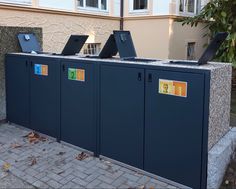 three laptops are sitting on top of two metal lockers in front of a building