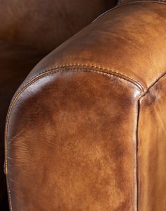 the back end of a brown leather chair