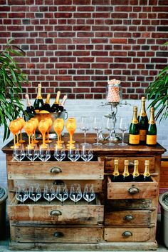 an old chest with wine glasses and bottles on it