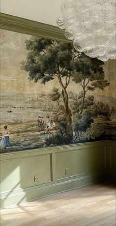 a room with a painting on the wall next to a chandelier