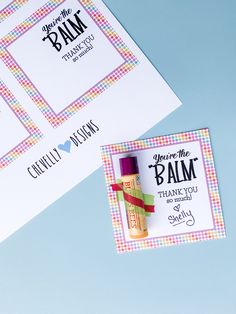 two personalized thank you notes and a lip balm bottle on a blue background