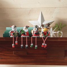 christmas ornaments are hanging on a shelf next to a star