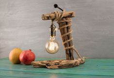 a light bulb sitting on top of a wooden table next to two pieces of wood